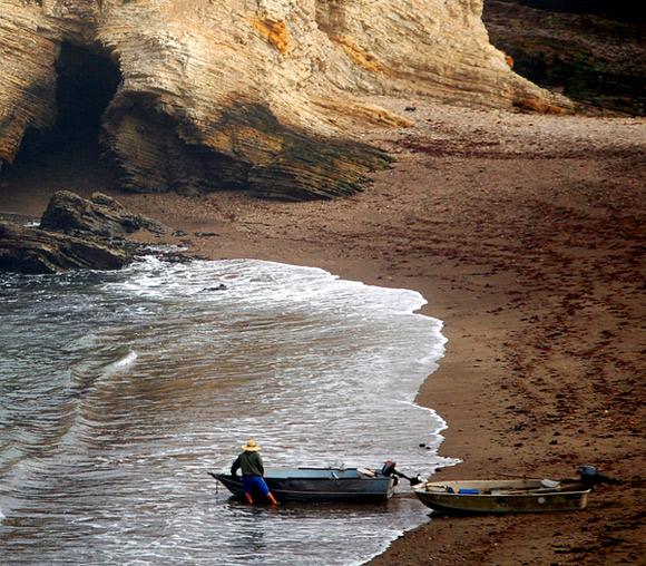 One guy, two boats, incoming tide