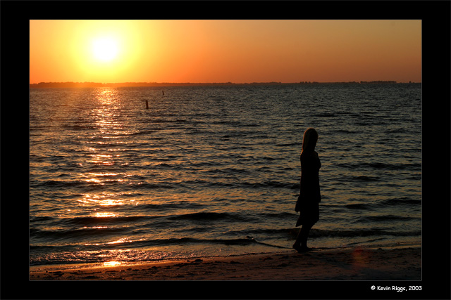 Model in silhouette on beach