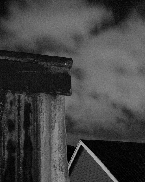 tin shed and incoming clouds