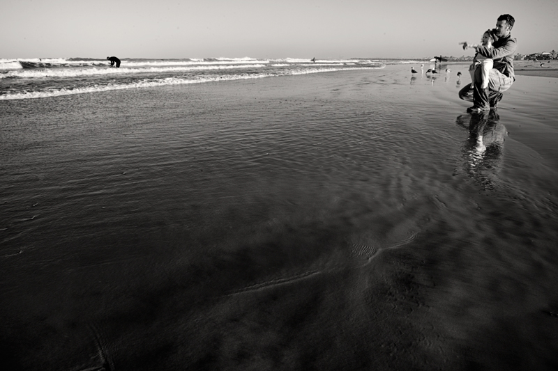 sophia, me, and a surfer or two...eta: a gaggle of gulls