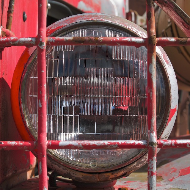 a square within a circle represented by a truck headlight and gravel guard