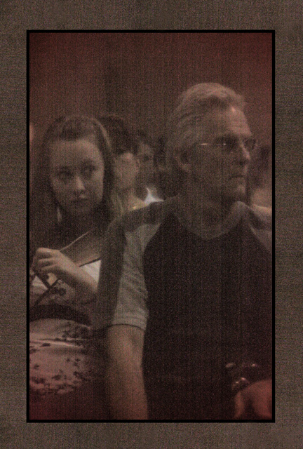 Watching the Graduation ... image is reflection in piano