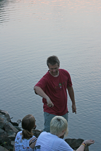 Alan schooling Lin and Grace on the art of skipping stones